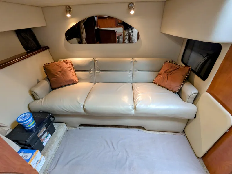 Slide: The Image of Interior of 2006 Cruisers Yachts 320 Express with beige leather sofa and cushions. - 15