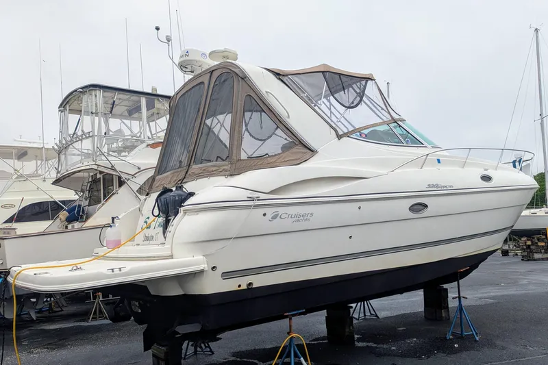Slide: The Image of 2006 Cruisers Yachts 320 Express on stands, in a boatyard setting. - 2