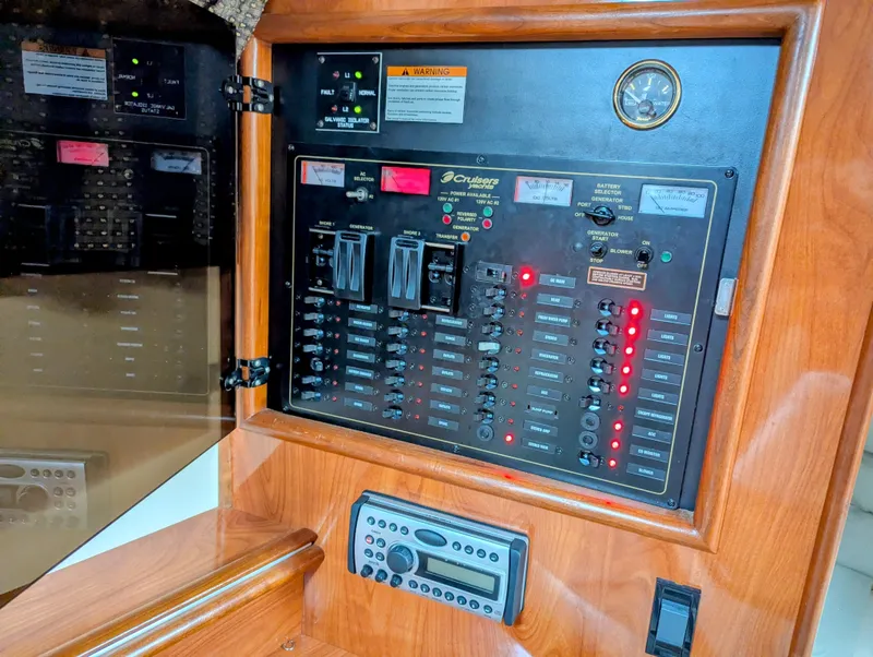 Slide: The Image of Electrical control panel of 2006 Cruisers Yachts 320 Express with switches and gauges. - 20