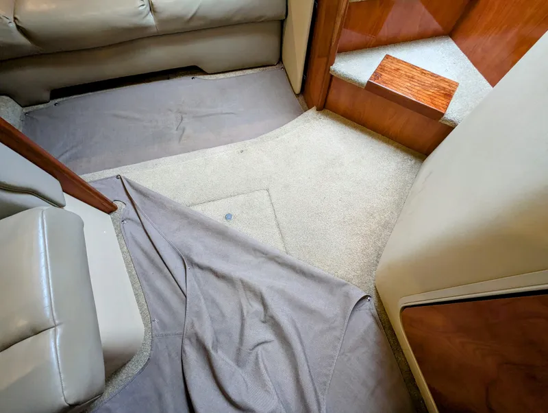Slide: The Image of Interior of 2006 Cruisers Yachts 320 Express, featuring carpeted flooring and leather seating. - 22