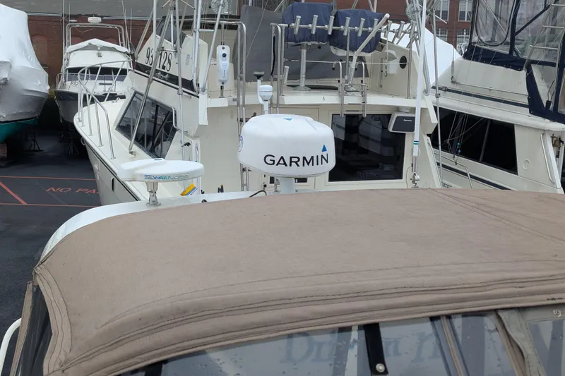 Slide: The Image of 2006 Cruisers Yachts 320 Express with Garmin radar, docked among other boats. - 24