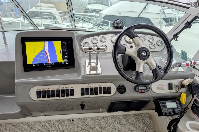 Slide: The Image of Helm of 2006 Cruisers Yachts 320 Express with navigation display and steering wheel. - 4