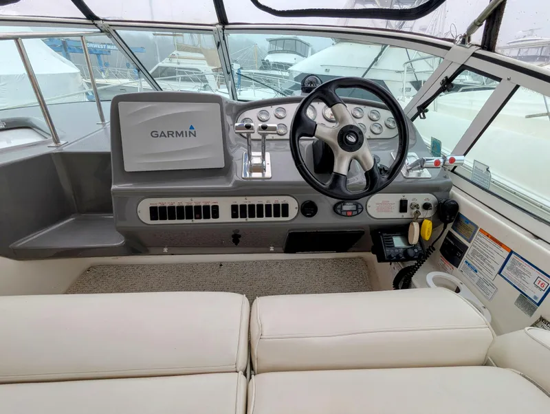 Slide: The Image of 2006 Cruisers Yachts 320 Express helm with Garmin navigation and leather seating. - 5