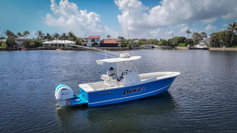 Slide: The Image of 2019 Regulator 25 boat on calm water with scenic background. - 0