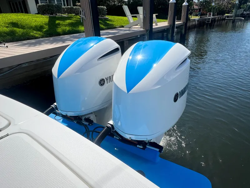 Slide: The Image of Twin Yamaha outboard engines on a 2019 Regulator 25 boat docked by the water. - 13