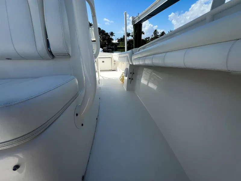 Slide: The Image of 2019 Regulator 25 boat interior with white seating and clear sky background. - 24