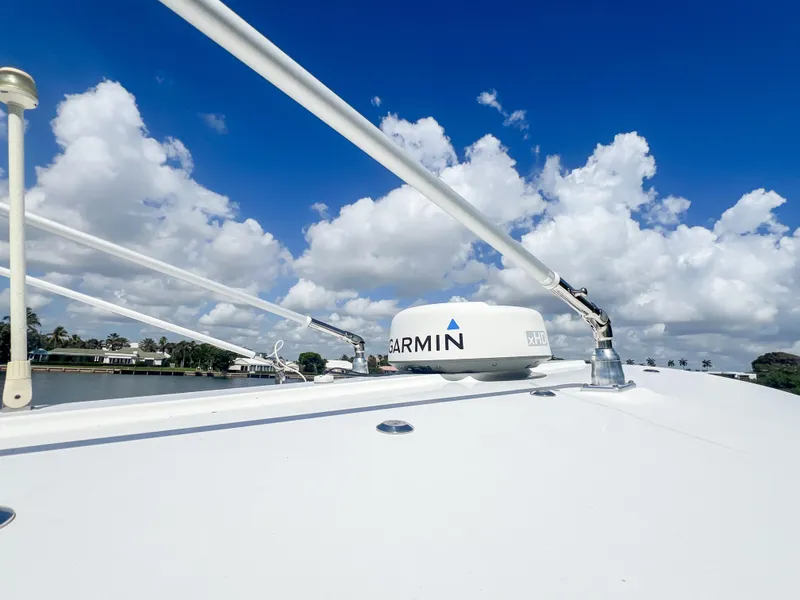 Slide: The Image of 2019 Regulator 25 boat with Garmin radar against a blue sky and clouds. - 27