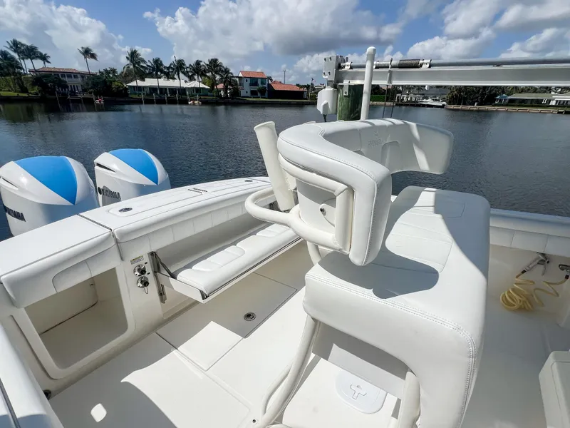 Slide: The Image of 2019 Regulator 25 boat with dual engines, white seating, and scenic waterfront view. - 31