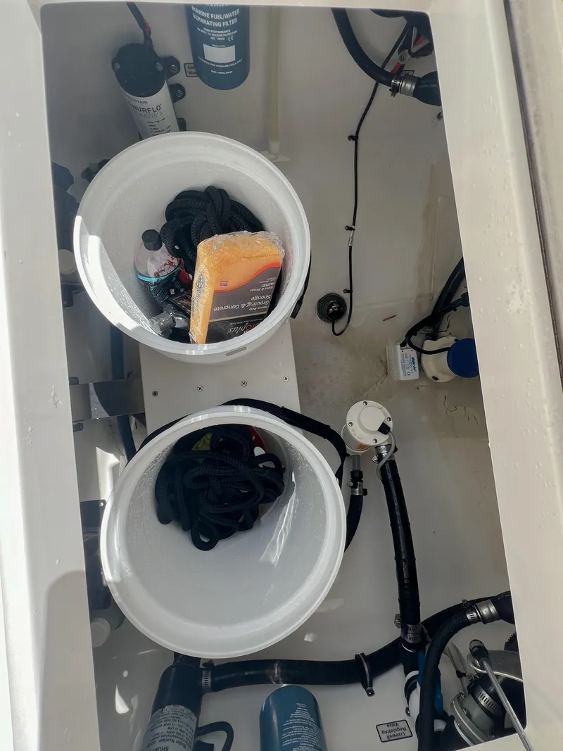 Slide: The Image of 2019 Regulator 25 boat storage compartment with equipment and supplies. - 32