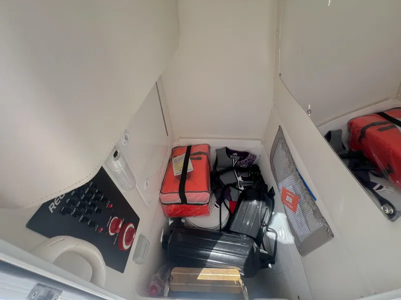 Slide: The Image of 2019 Regulator 25 cabin interior with safety equipment and storage. - 33