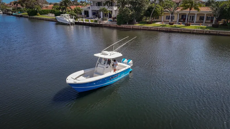 Slide: The Image of 2019 Regulator 25 boat on calm water near waterfront homes. - 4