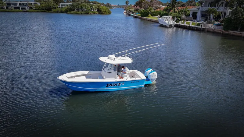 Slide: The Image of 2019 Regulator 25 boat on calm water near waterfront homes. - 5