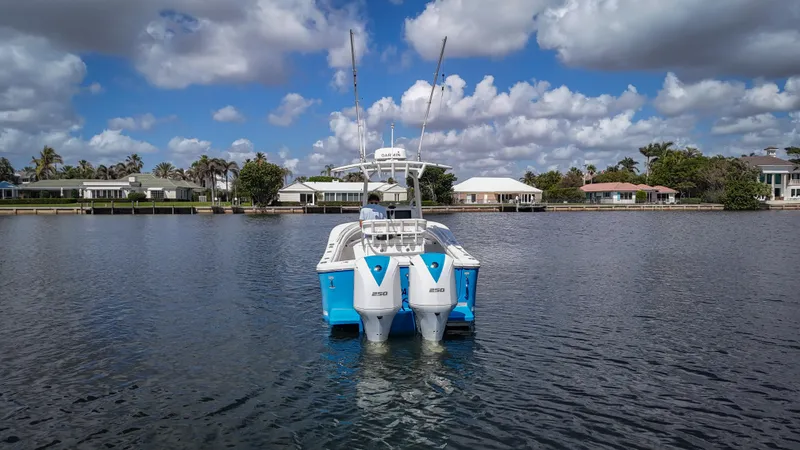 Slide: The Image of 2019 Regulator 25 boat on calm water with scenic waterfront homes. - 9