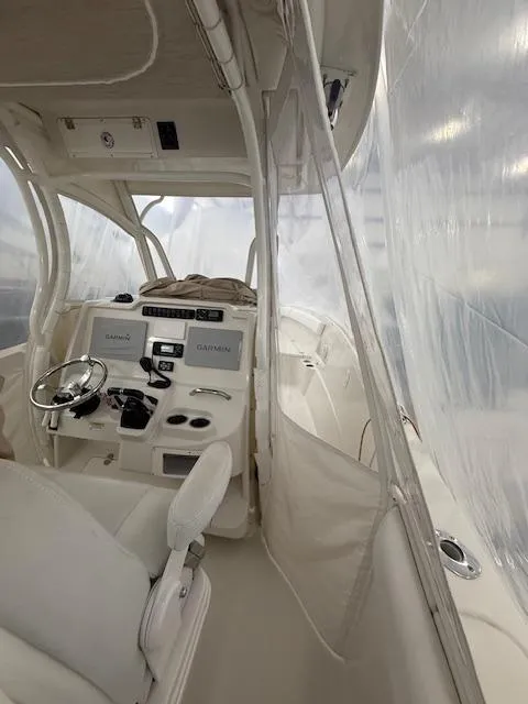 Slide: The Image of 2015 Sailfish 290 CC boat interior with helm, steering wheel, and navigation equipment. - 10