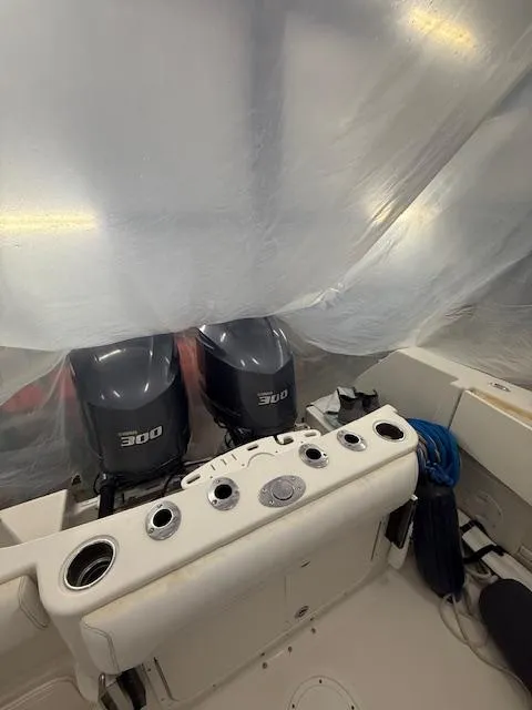 Slide: The Image of 2015 Sailfish 290 CC boat with dual 300 horsepower engines, covered and stored. - 11