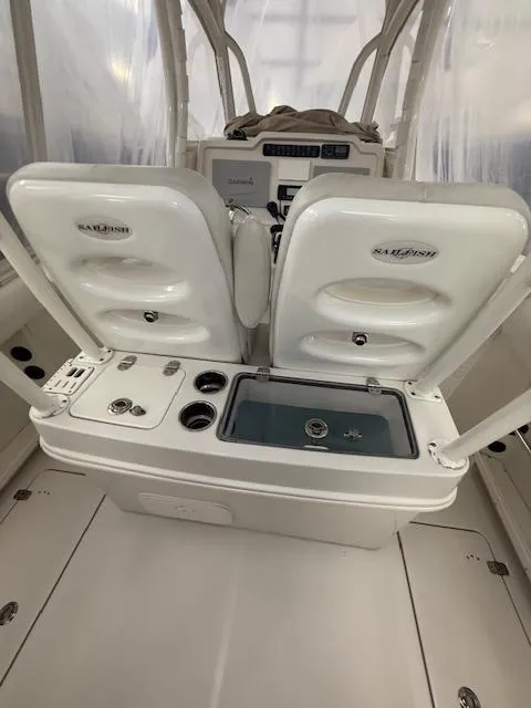 Slide: The Image of 2015 Sailfish 290 CC boat interior with dual seats and control panel. - 7