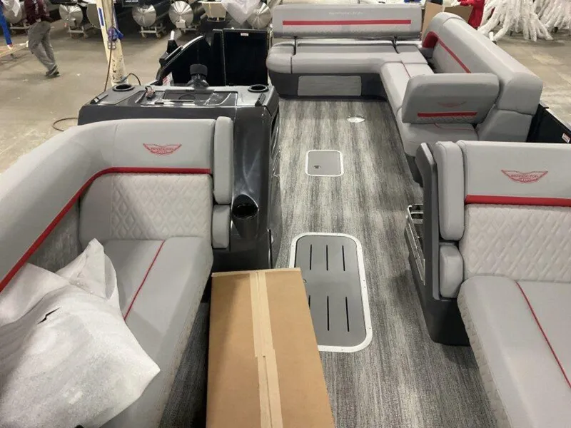 Slide: The Image of 2025 Bennington 24MLSE pontoon boat interior with gray seating and red accents. - 15