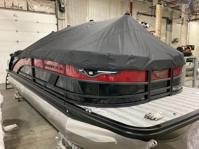 Slide: The Image of 2025 Bennington 24MLSE pontoon boat with cover in a garage setting. - 3