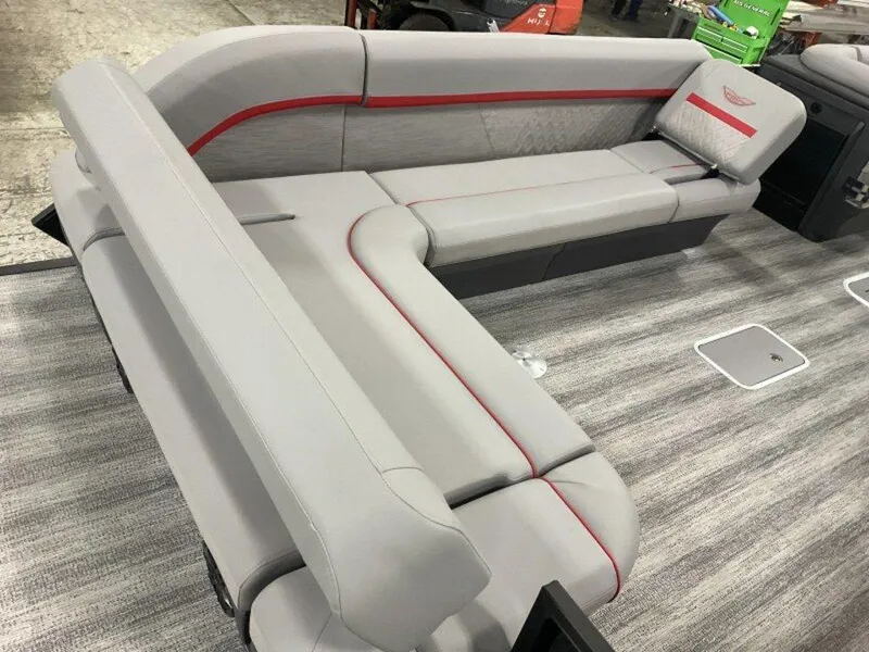 Slide: The Image of 2025 Bennington 24MLSE boat interior with gray and red seating on a textured floor. - 7