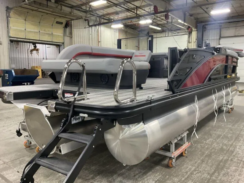 Slide: The Image of 2025 Bennington 24MLSE pontoon boat in a warehouse setting. - 8