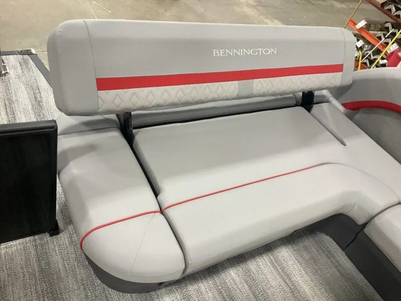 Slide: The Image of 2025 Bennington 24MLSE boat seating with gray upholstery and red accents. - 9