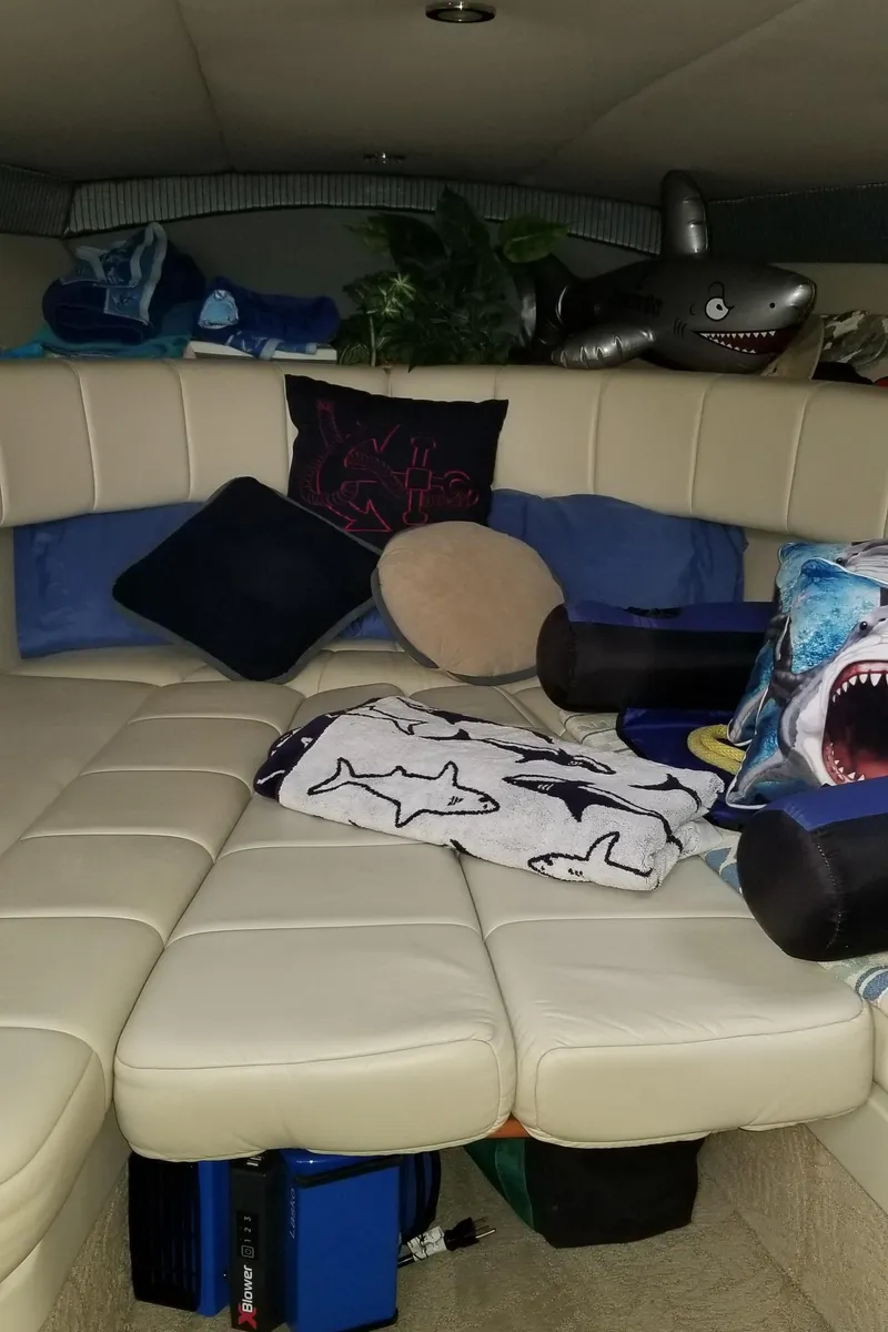 Slide: The Image of Interior of 2006 Formula 330 SS boat with plush seating and shark-themed decor. - 14