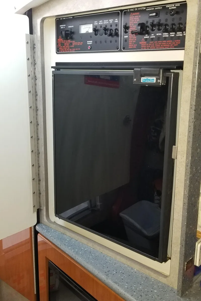 Slide: The Image of Control panel and refrigerator in 2006 Formula 330 SS boat interior. - 17