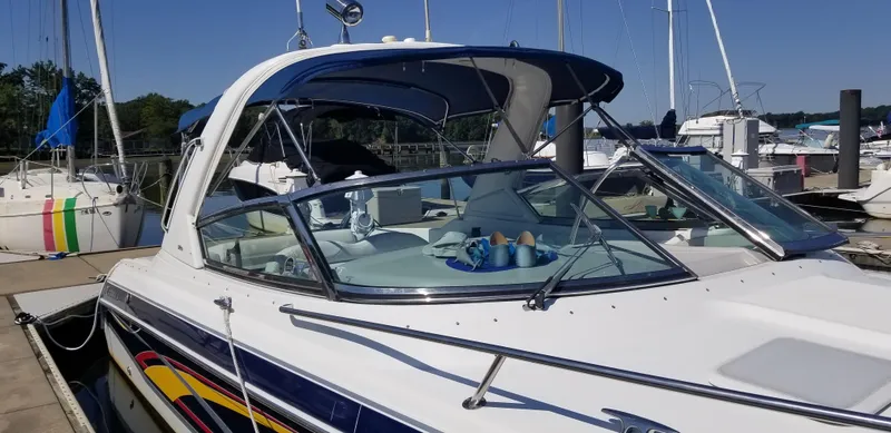 Slide: The Image of 2006 Formula 330 SS boat docked at a marina under clear blue skies. - 2