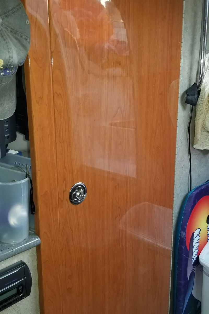 Slide: The Image of Wooden cabin door inside a 2006 Formula 330 SS boat, featuring a sleek handle. - 20