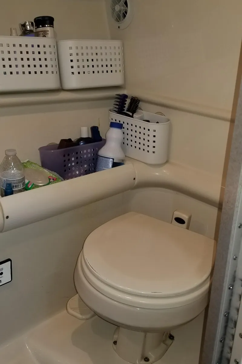 Slide: The Image of 2006 Formula 330 SS boat bathroom with storage baskets and toiletries. - 21