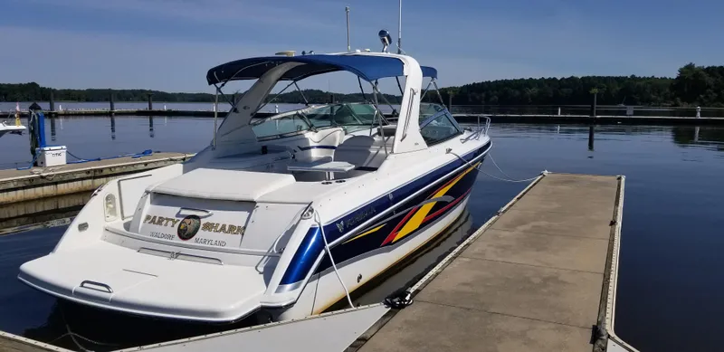 Slide: The Image of 2006 Formula 330 SS boat docked at a marina, featuring sleek design and vibrant graphics. - 3