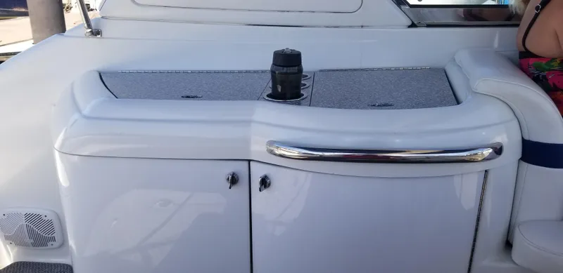 Slide: The Image of 2006 Formula 330 SS boat interior with sleek white cabinetry and chrome accents. - 9