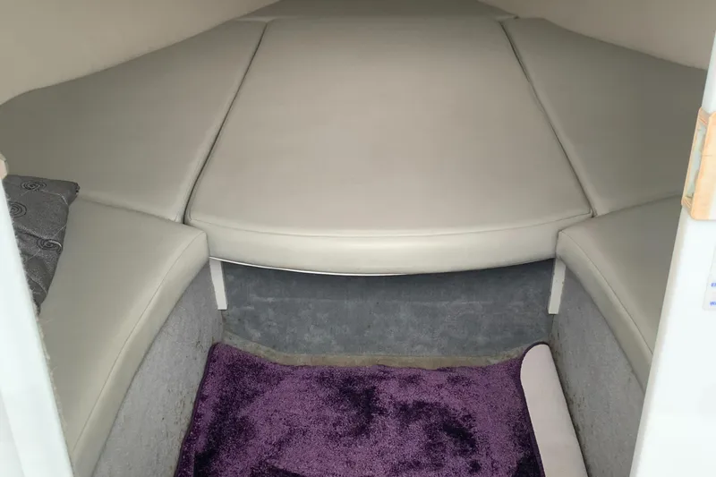 Slide: The Image of 2003 Baja 24 H2X Boss boat interior with cushioned seating and purple carpet. - 6