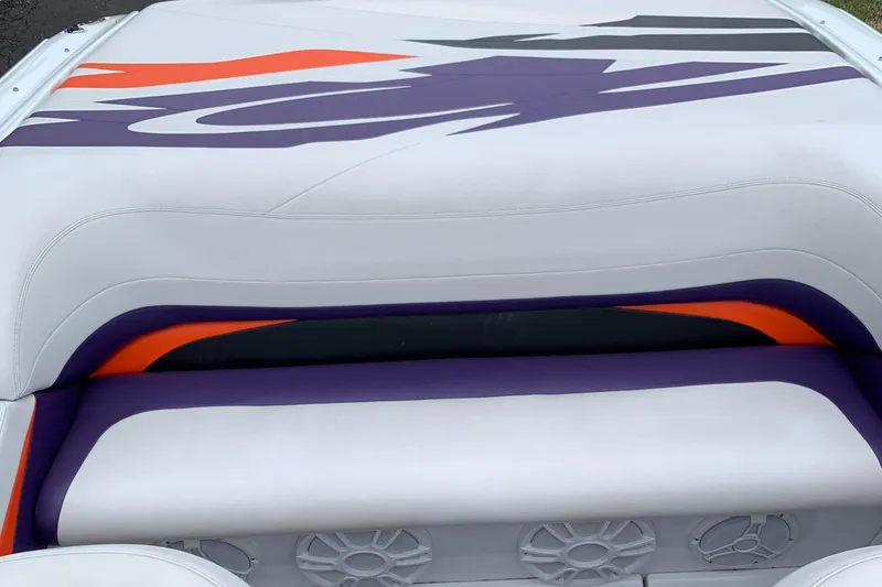 Slide: The Image of 2003 Baja 24 H2X Boss boat interior with vibrant purple and orange accents. - 9