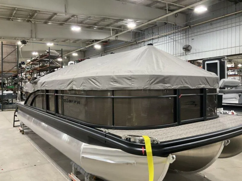 Slide: The Image of 2025 Bennington SX L-Bench 23 SXL pontoon boat covered in a warehouse setting. - 11