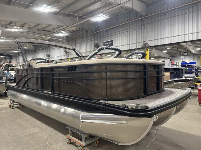 Slide: The Image of 2025 Bennington SX L-Bench 23 SXL pontoon boat in a showroom setting. - 14
