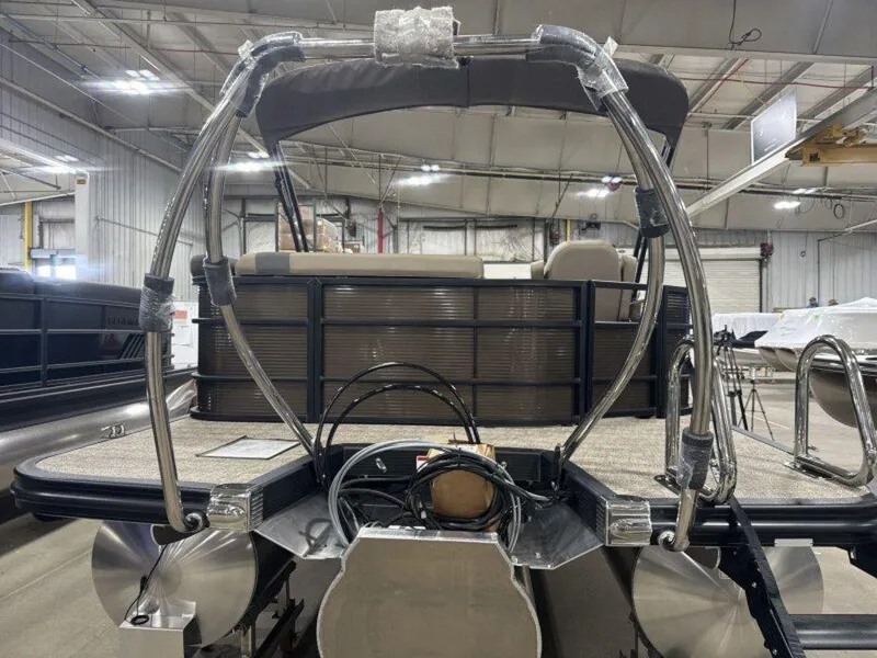 Slide: The Image of 2025 Bennington SX L-Bench 23 SXL pontoon boat in a warehouse setting. - 15