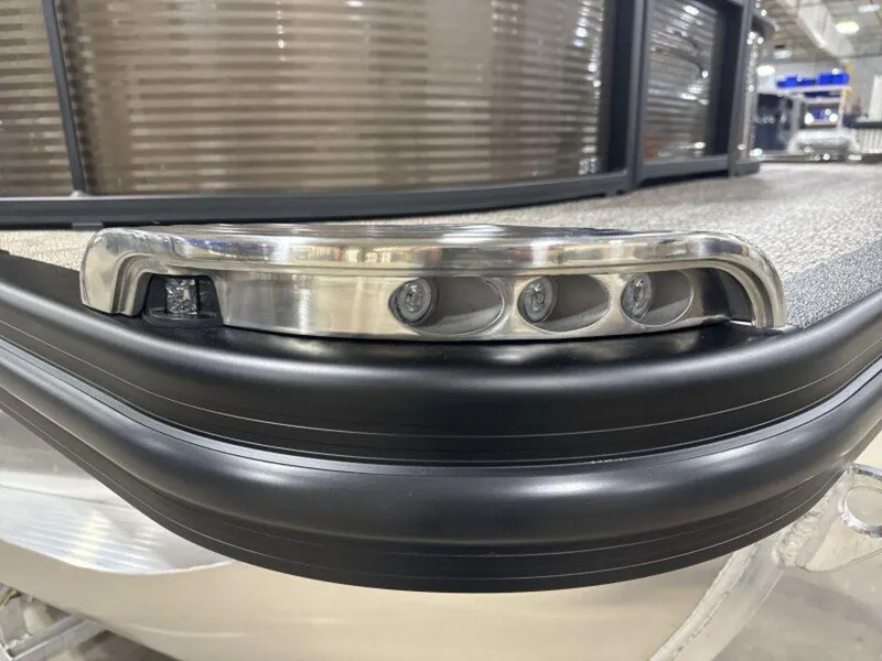 Slide: The Image of 2025 Bennington SX L-Bench 23 SXL pontoon boat with sleek LED lighting detail. - 16
