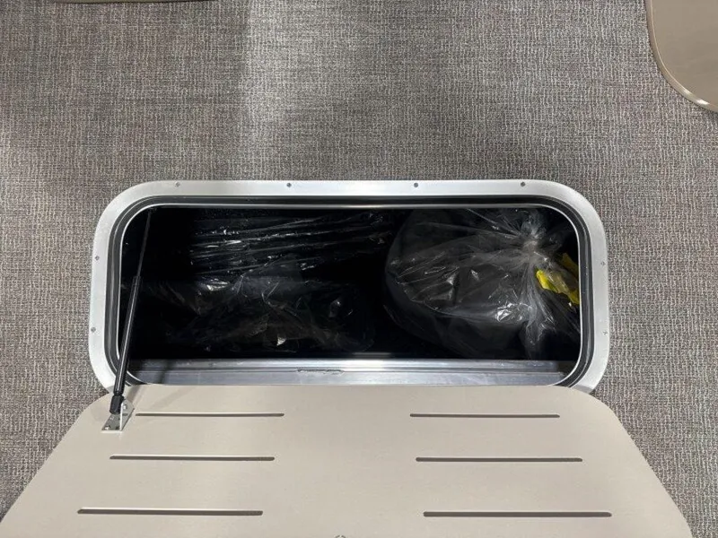 Slide: The Image of Storage compartment in 2025 Bennington SX L-Bench 23 SXL boat, featuring sleek design and ample space. - 17
