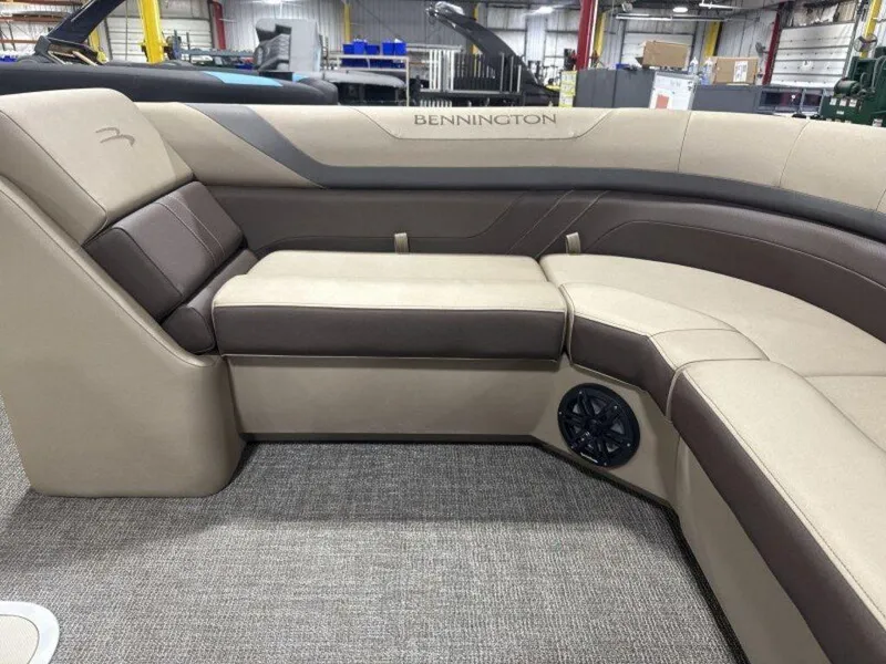 Slide: The Image of 2025 Bennington SX L-Bench 23 SXL boat interior with beige and brown seating. - 18