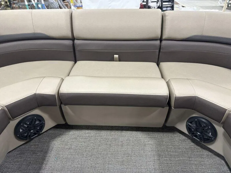 Slide: The Image of 2025 Bennington SX L-Bench 23 SXL boat seating with integrated speakers, beige and brown upholstery. - 19