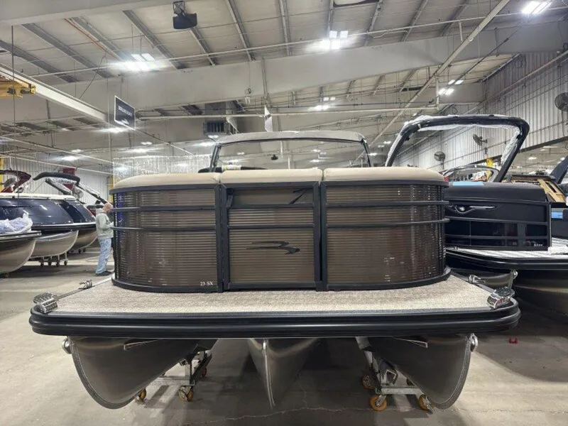 Slide: The Image of 2025 Bennington SX L-Bench 23 SXL pontoon boat in a showroom setting. - 2