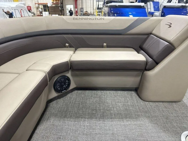 Slide: The Image of 2025 Bennington SX L-Bench 23 SXL boat interior with beige and brown seating. - 20