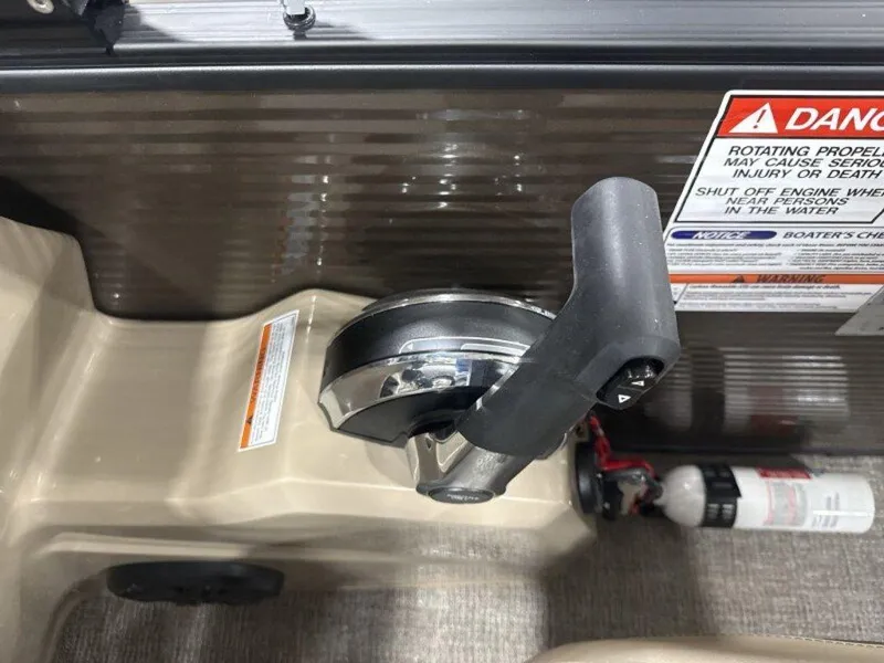 Slide: The Image of Throttle control and safety warnings on a 2025 Bennington SX L-Bench 23 SXL boat. - 23