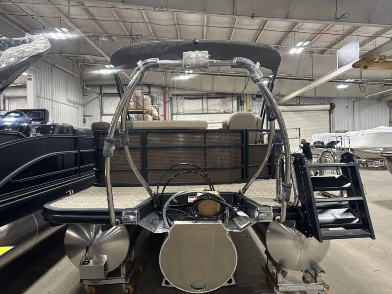 Slide: The Image of 2025 Bennington SX L-Bench 23 SXL pontoon boat in a warehouse setting. - 7