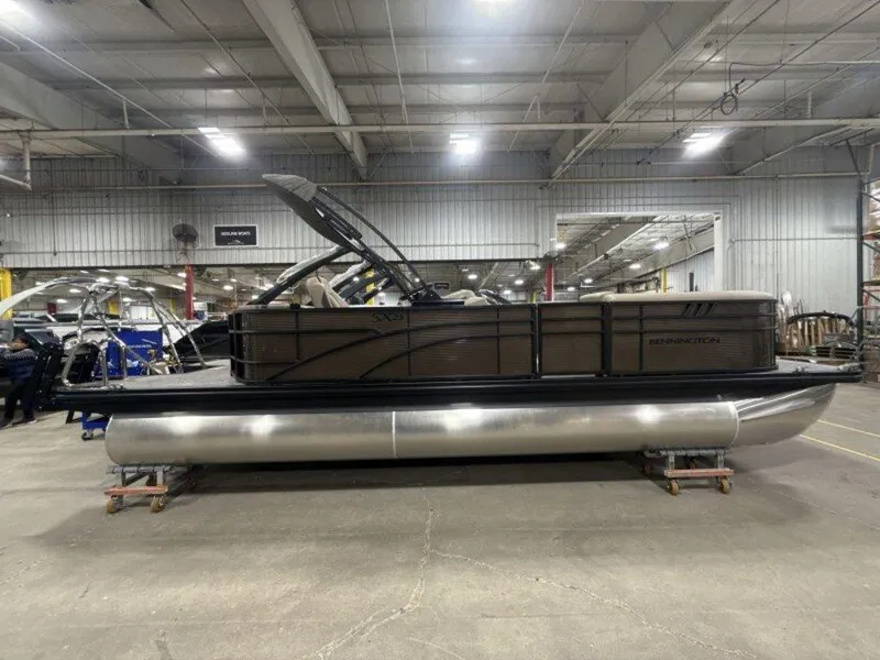 Slide: The Image of 2025 Bennington SX L-Bench 23 SXL pontoon boat in a warehouse setting. - 8