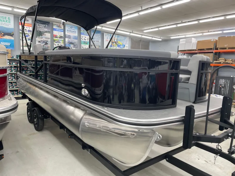 Slide: The Image of 2025 Lowe LS230W pontoon boat in showroom, featuring sleek design and modern amenities. - 3