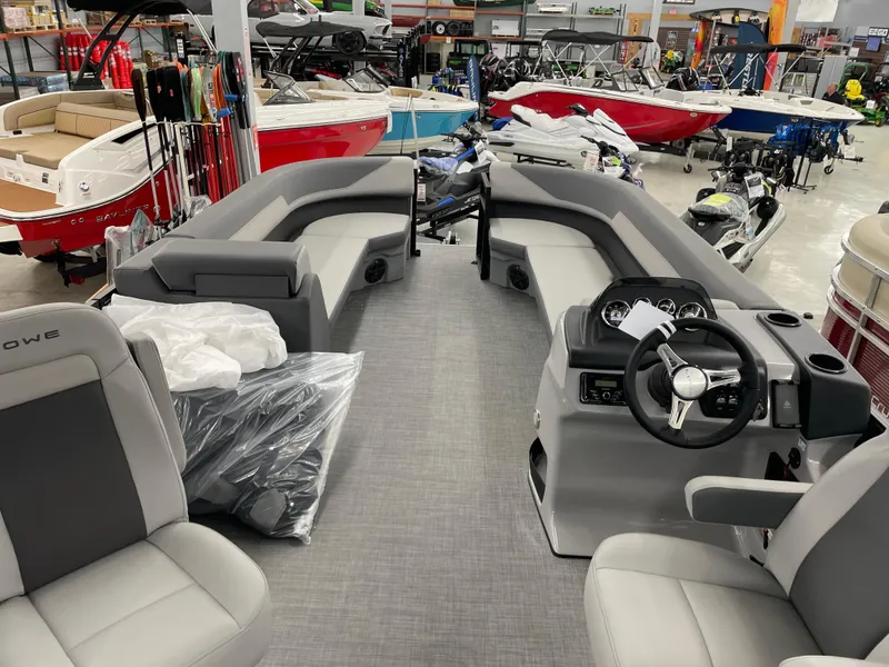 Slide: The Image of Interior view of a 2025 Lowe LS230W pontoon boat in a showroom. - 5