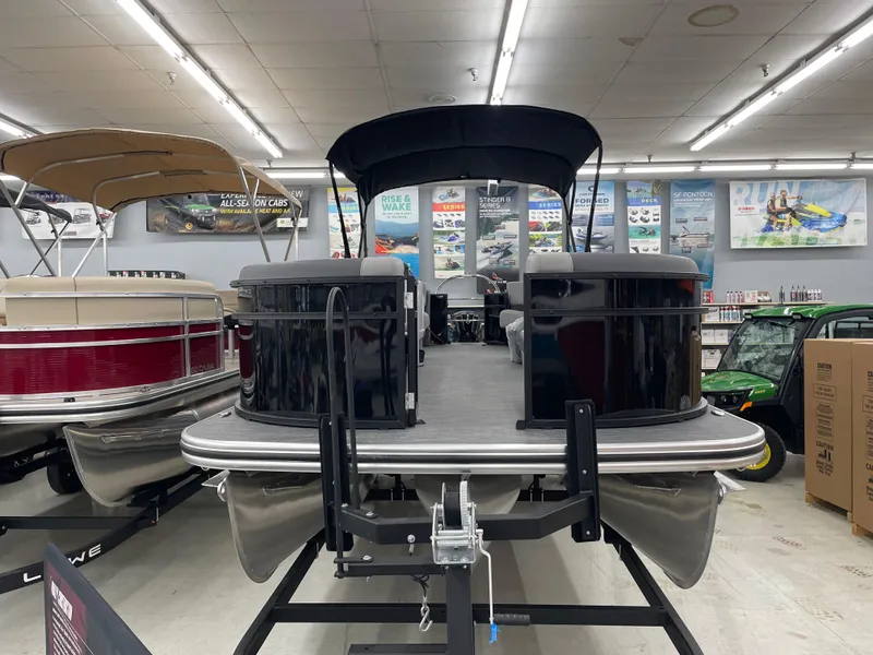 Slide: The Image of Lowe LS230W pontoon boat displayed in showroom, 2025 model. - 6