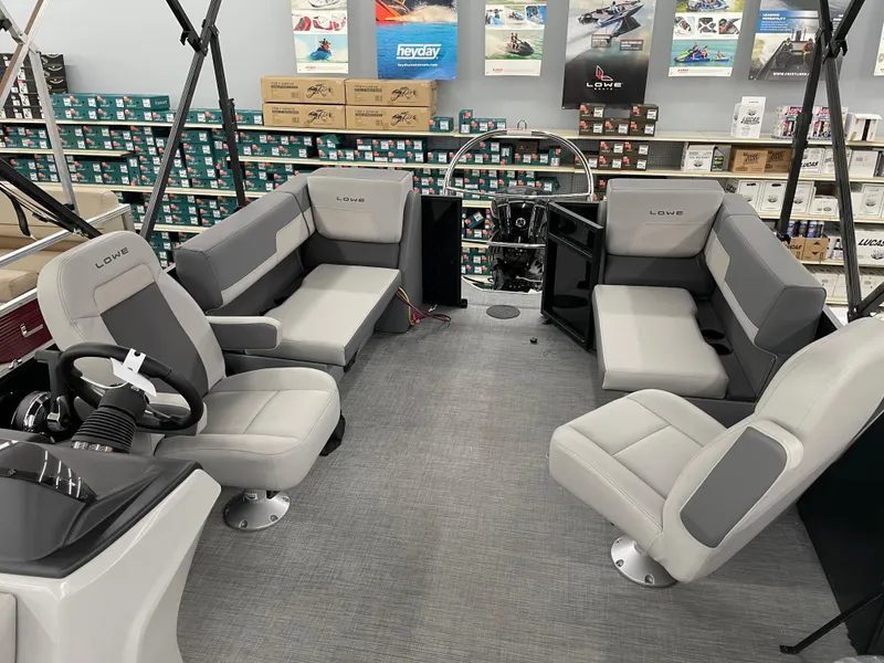 Slide: The Image of Interior of 2025 Lowe LS230W boat with gray seating and modern design. - 8